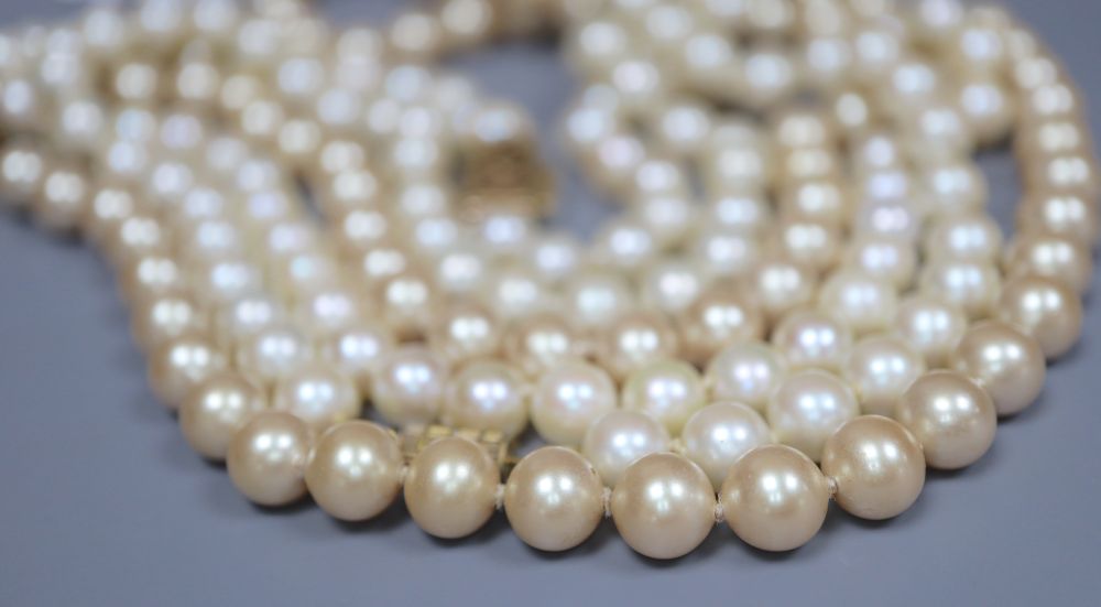 A single strand cultured pearl necklace and two simulated pearl necklaces.